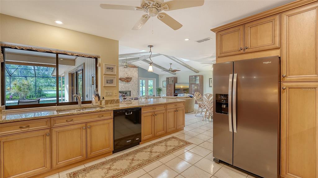 7426 Weeping Willow Boulevard Sarasota, FL 34241 - Photo 24 of 66 a kitchen with stainless steel appliances granite countertop a refrigerator a sink and white cabinets
