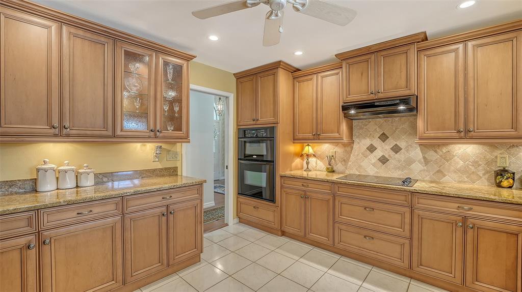 7426 Weeping Willow Boulevard Sarasota, FL 34241 - Photo 26 of 66 a kitchen with white cabinets and refrigerator