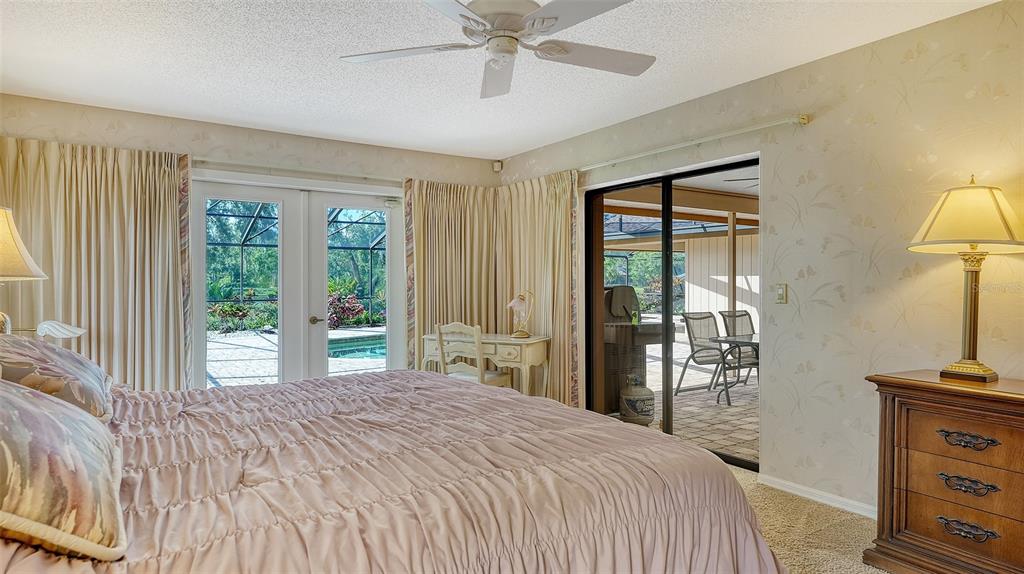 7426 Weeping Willow Boulevard Sarasota, FL 34241 - Photo 29 of 66 a bedroom with a bed and a flat tv screen on dresser