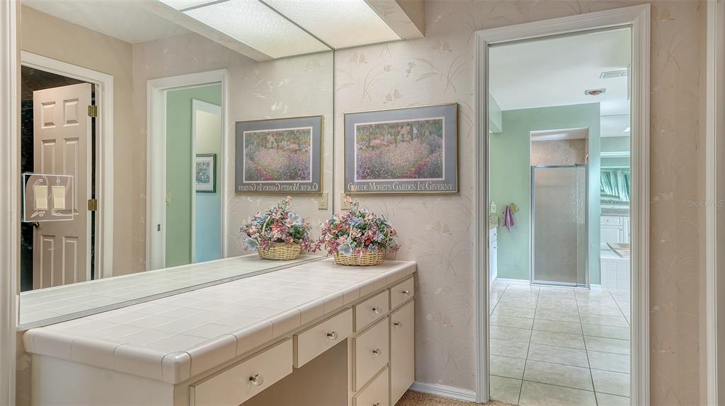 7426 Weeping Willow Boulevard Sarasota, FL 34241 - Photo 31 of 66 a bathroom with a sink vanity and a mirror