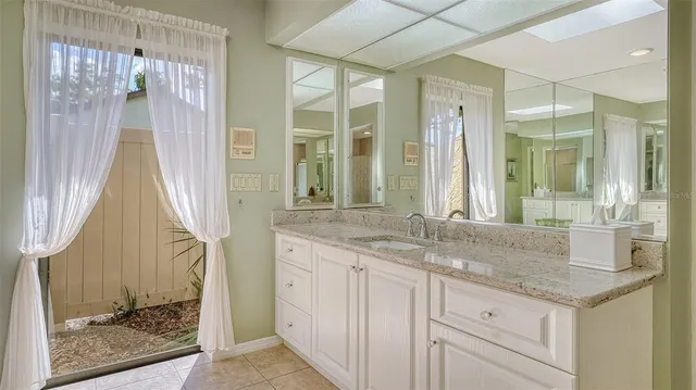 a bathroom with a sink and a mirror