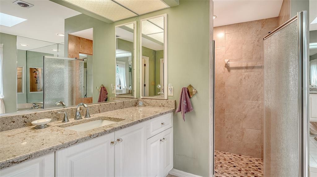 7426 Weeping Willow Boulevard Sarasota, FL 34241 - Photo 36 of 66 a bathroom with a granite countertop sink and a mirror