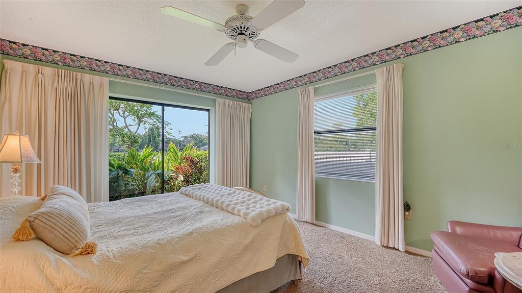7426 Weeping Willow Boulevard Sarasota, FL 34241 - Photo 39 of 66 a bedroom with a bed and a large window