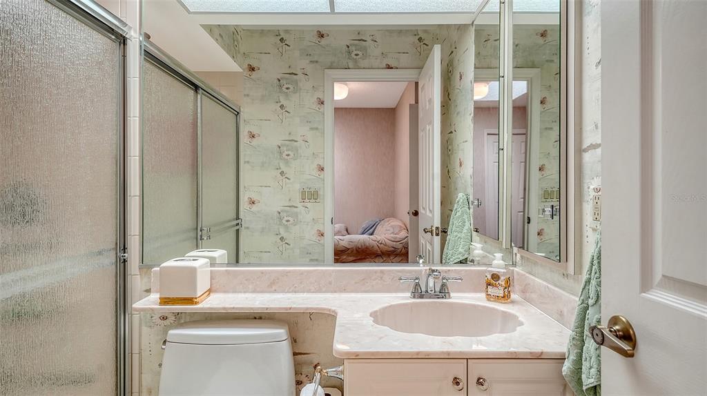 7426 Weeping Willow Boulevard Sarasota, FL 34241 - Photo 46 of 66 a bathroom with a sink and a mirror