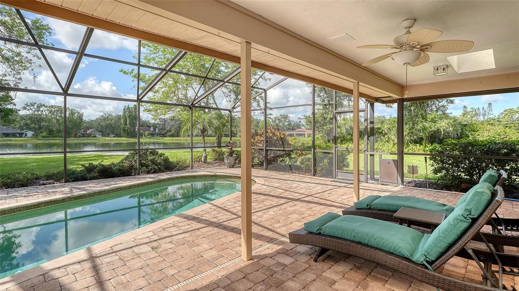 7426 Weeping Willow Boulevard Sarasota, FL 34241 - Photo 50 of 66 a living room with large glass windows and a table