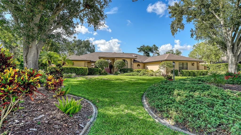 7426 Weeping Willow Boulevard Sarasota, FL 34241 - Photo 5 of 66 a front view of a house with a yard