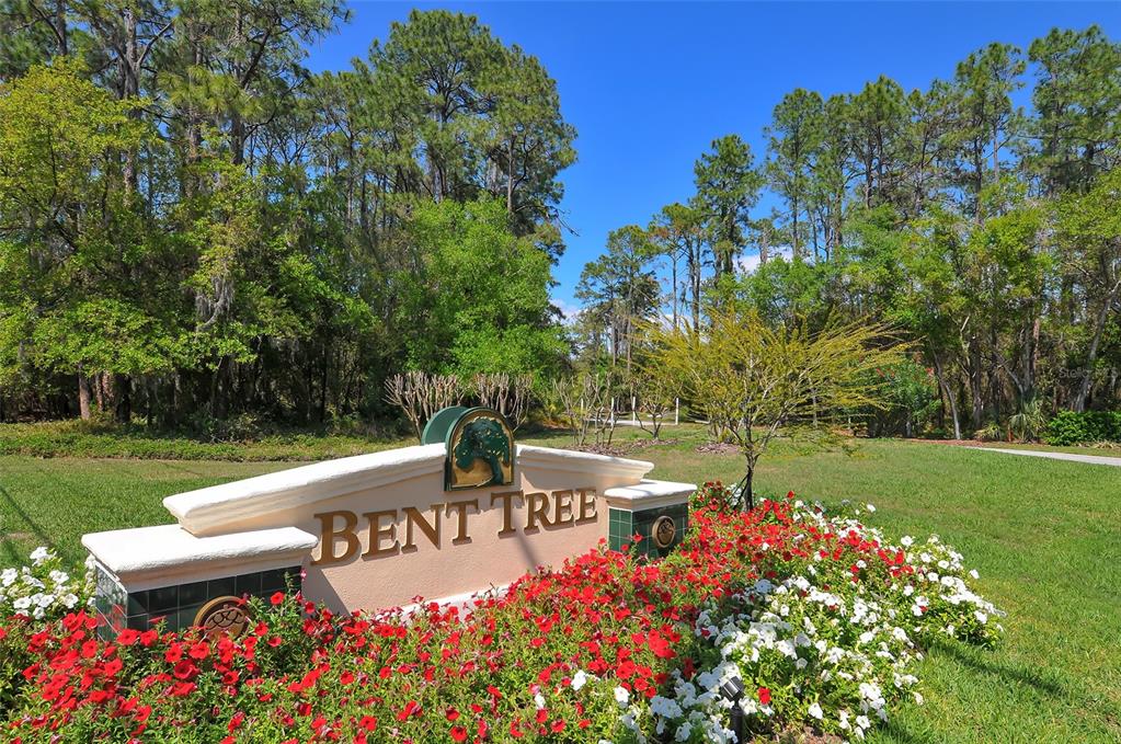 7426 Weeping Willow Boulevard Sarasota, FL 34241 - Photo 65 of 66 a view of a bench in a garden near a lake
