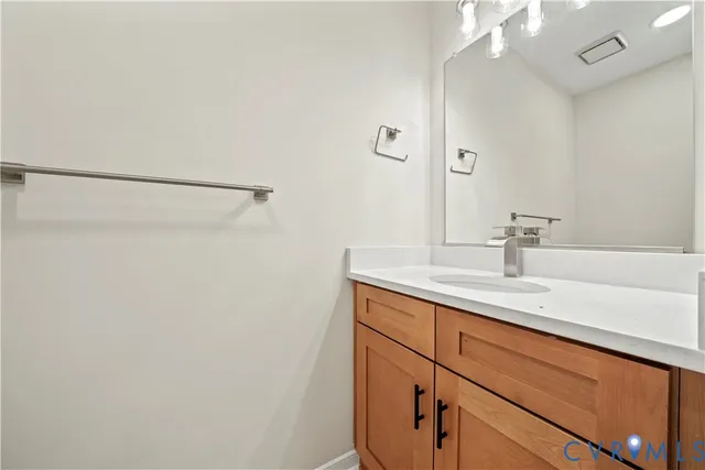 a bathroom with a sink a vanity and a mirror