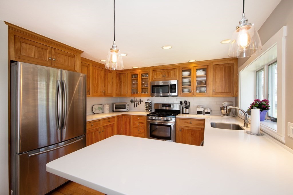 12 Hawley Road Scituate, MA 02066 - Photo 11 of 36 a kitchen with stainless steel appliances granite countertop a refrigerator stove microwave and sink