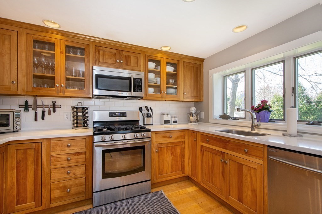 12 Hawley Road Scituate, MA 02066 - Photo 12 of 36 a kitchen with stainless steel appliances granite countertop a stove microwave and sink