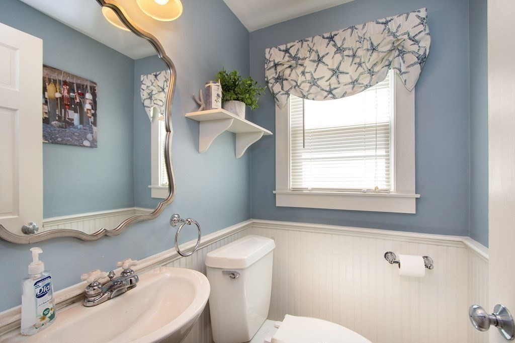 12 Hawley Road Scituate, MA 02066 - Photo 17 of 36 a bathroom with a sink mirror and toilet
