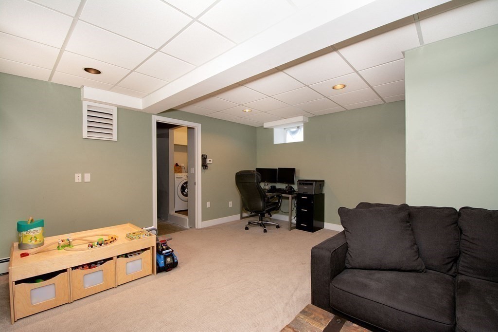 12 Hawley Road Scituate, MA 02066 - Photo 28 of 36 a living room with furniture and a flat screen tv