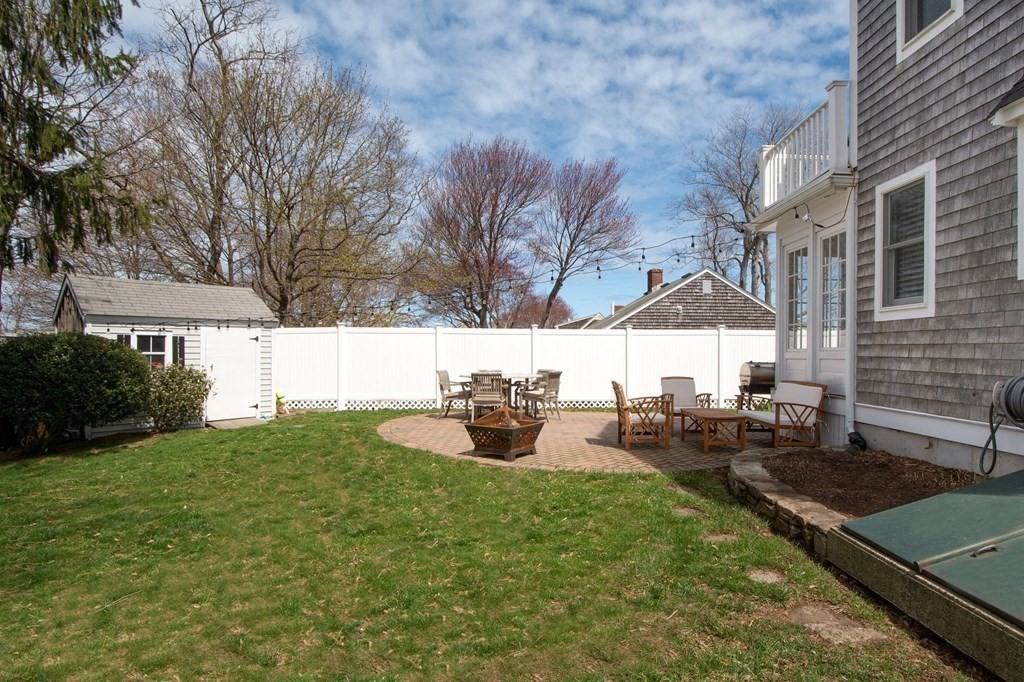 12 Hawley Road Scituate, MA 02066 - Photo 36 of 36 a view of a backyard with table and chairs under an umbrella