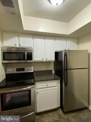 a kitchen with appliances and cabinets