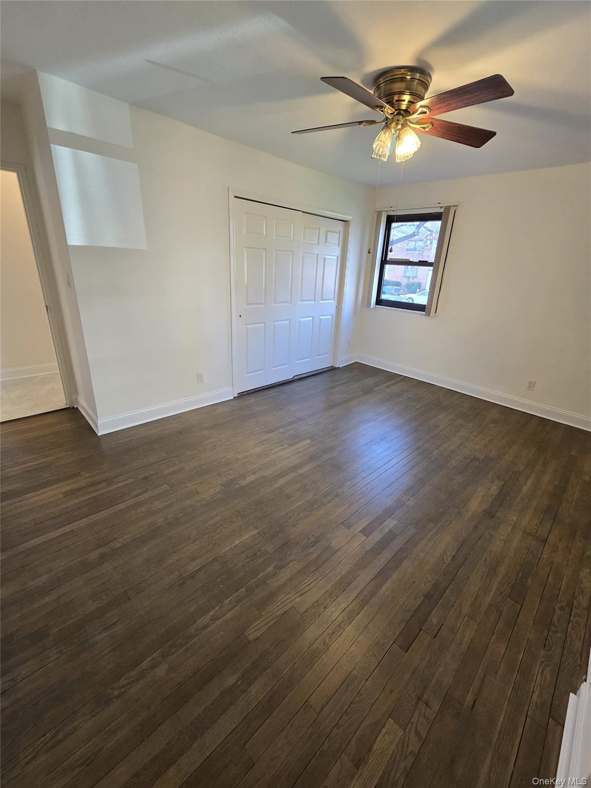 86-06 155th Avenue, Unit 4 Queens, NY 11414 - Photo 7 of 11 a view of an empty room with a window and wooden floor