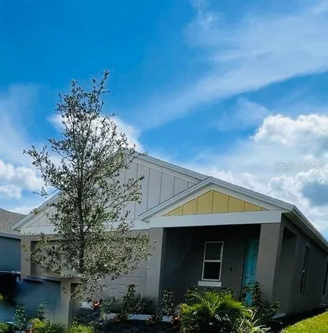 a front view of a house with plants