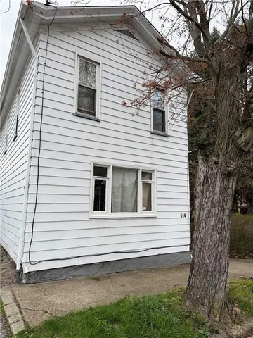 a view of a house with a yard and garage
