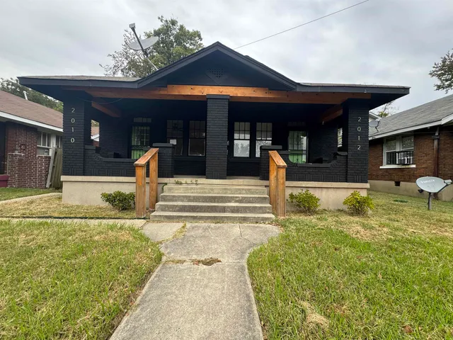a swimming pool in front of the house