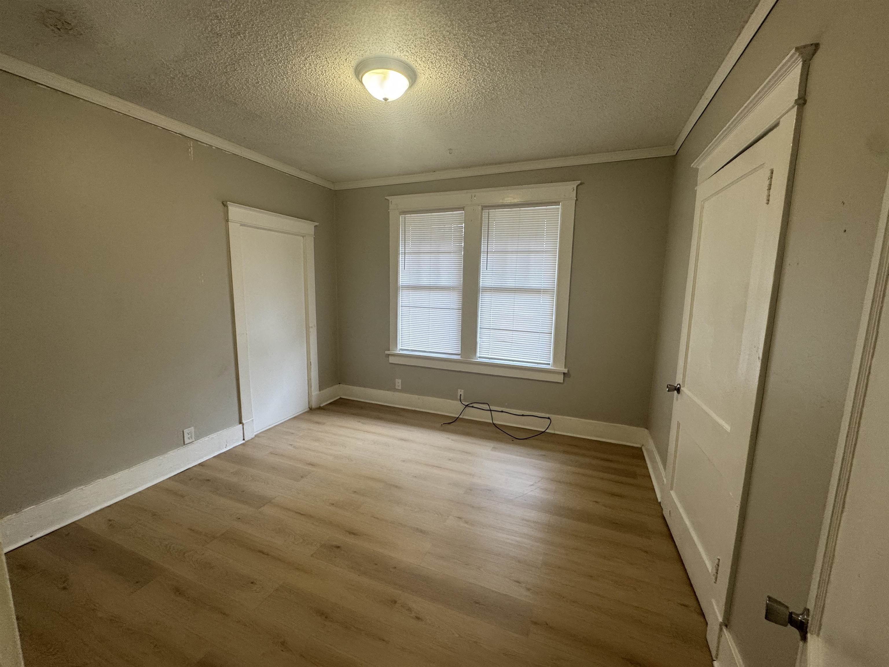 2012 Carnes Avenue Memphis, TN 38114 - Photo 13 of 28 an empty room with wooden floor and windows