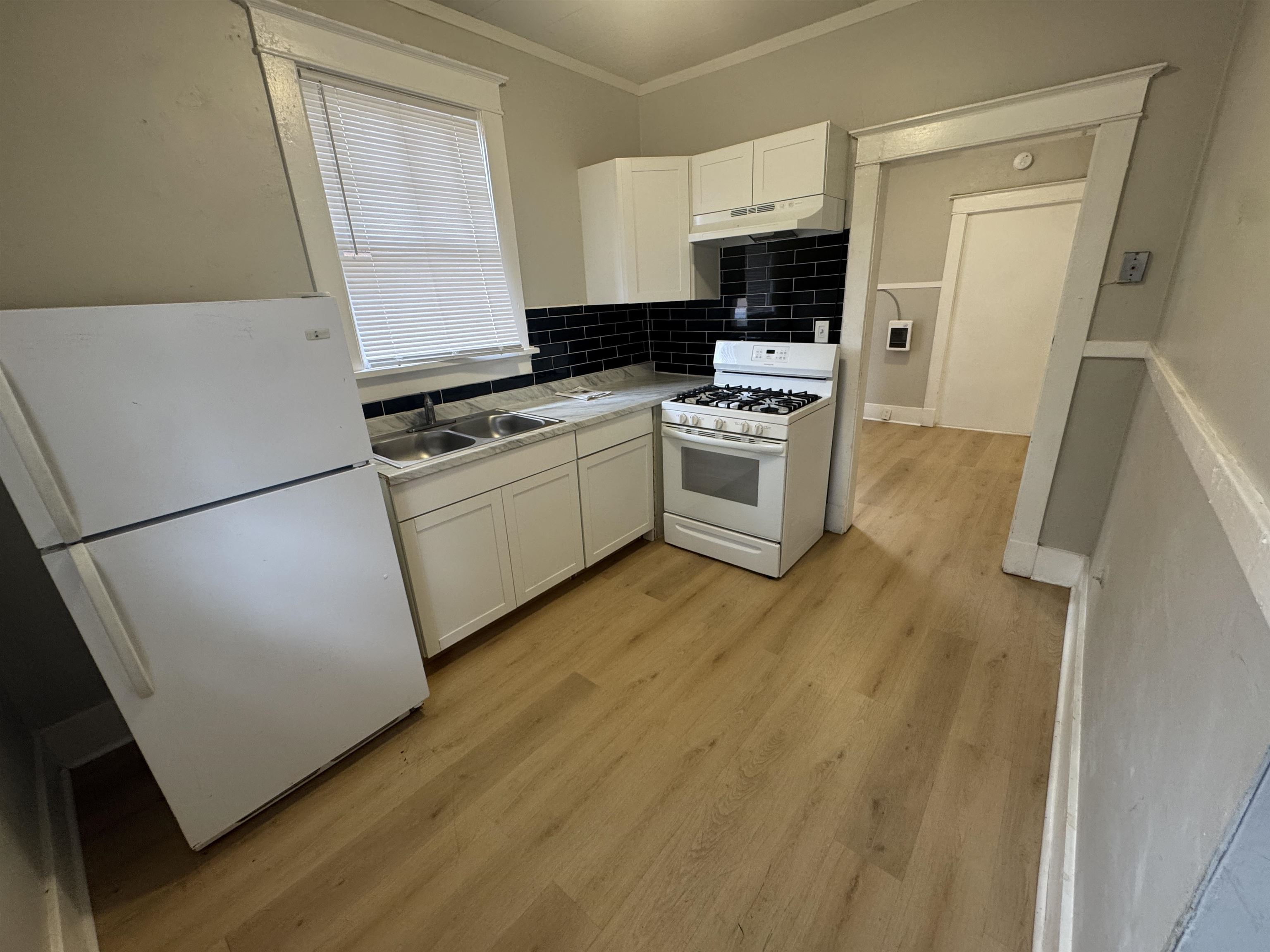 2012 Carnes Avenue Memphis, TN 38114 - Photo 17 of 28 a kitchen with a sink a stove top oven a refrigerator and a window