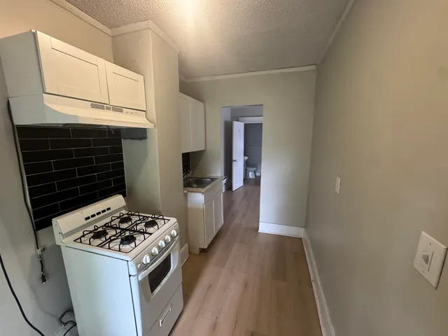 a bathroom with a sink a toilet a mirror and shower