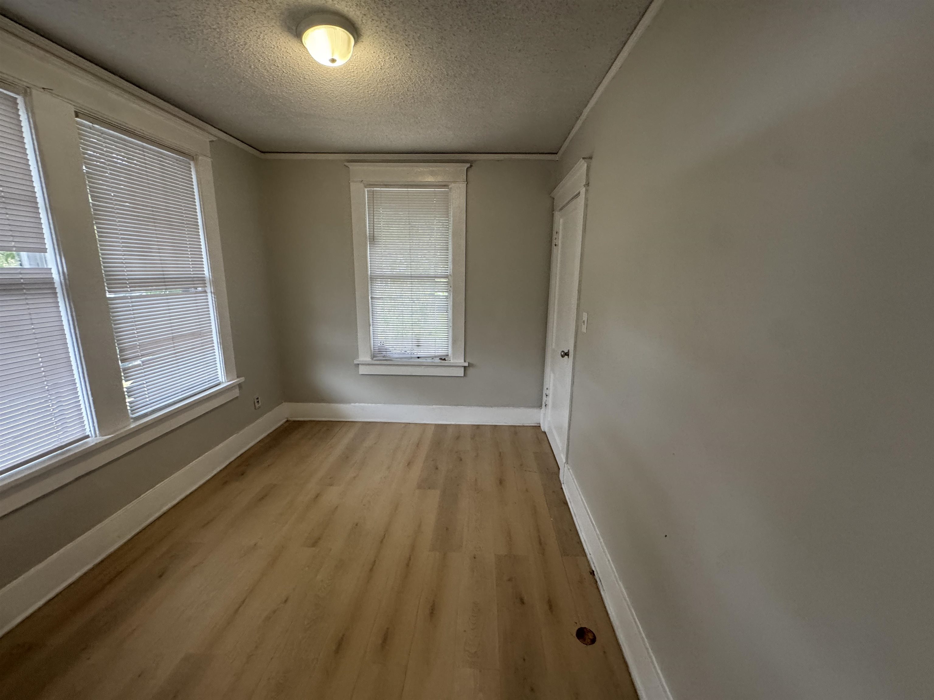 2012 Carnes Avenue Memphis, TN 38114 - Photo 20 of 28 an empty room with wooden floor and windows