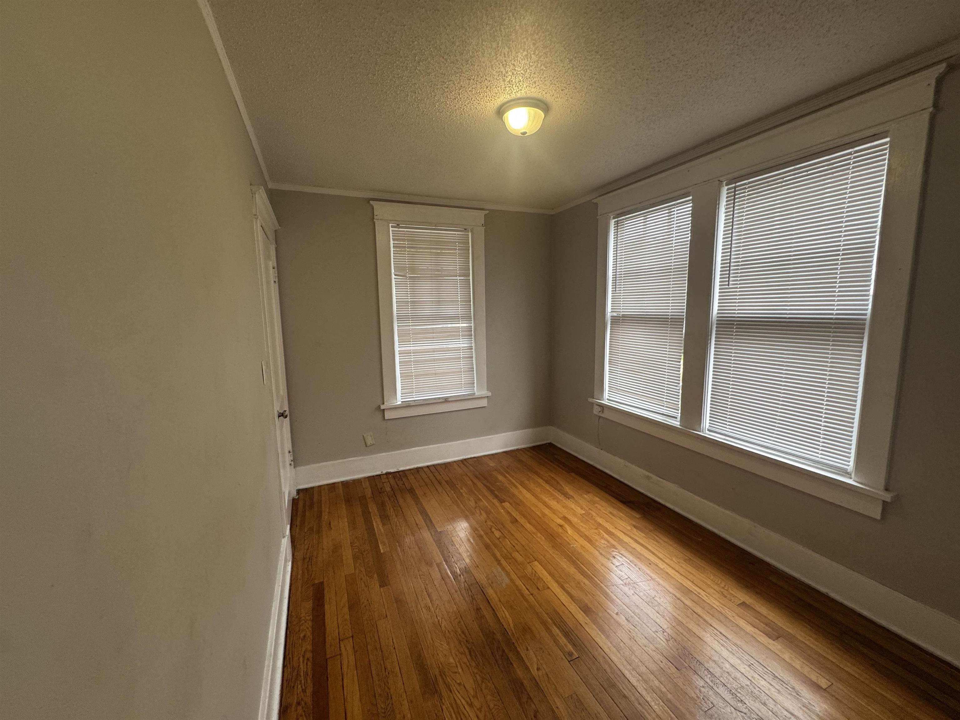 2012 Carnes Avenue Memphis, TN 38114 - Photo 24 of 28 an empty room with wooden floor and windows