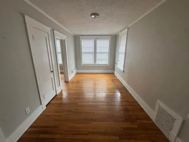 a kitchen with a refrigerator and white cabinets