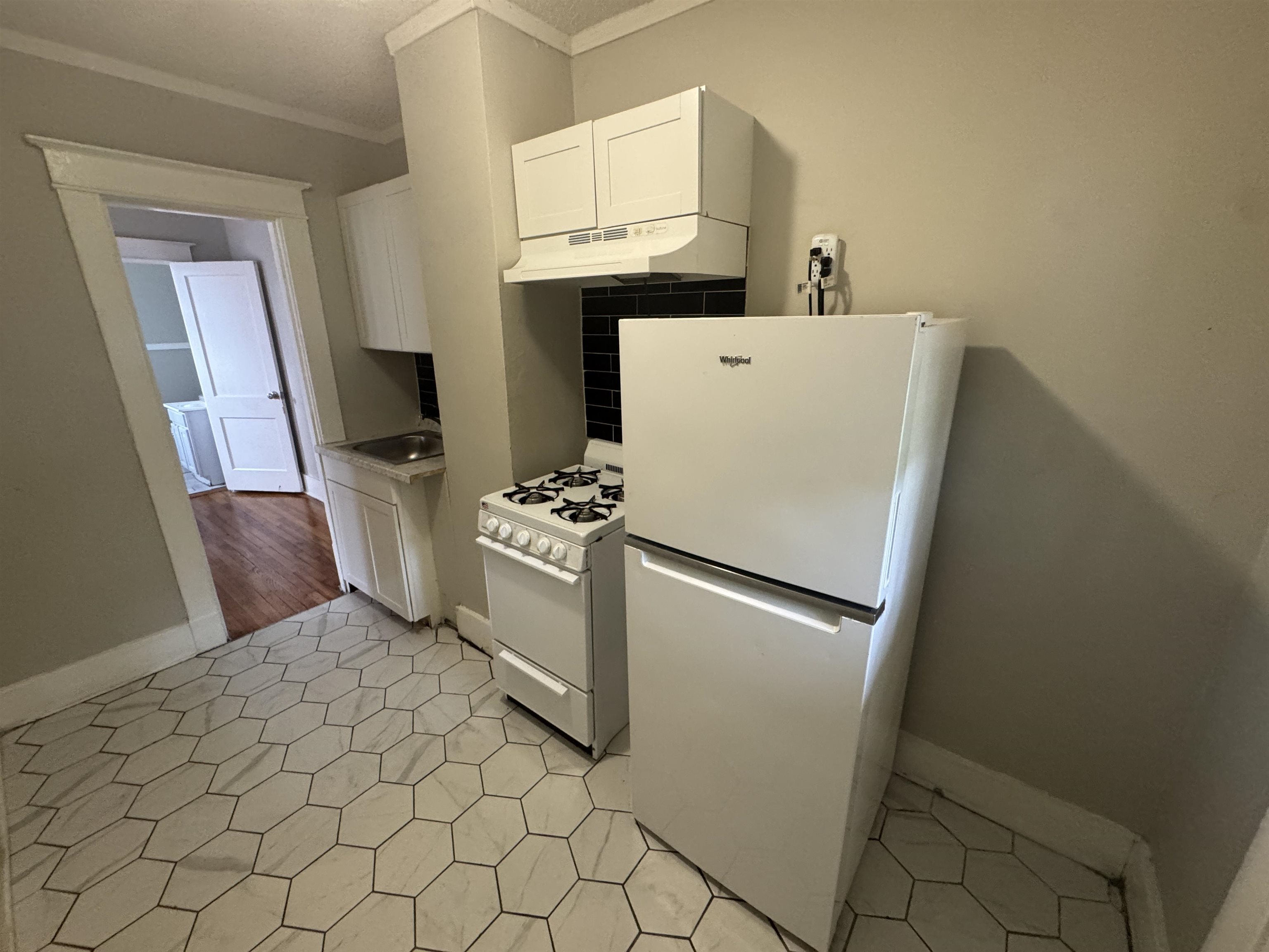 2012 Carnes Avenue Memphis, TN 38114 - Photo 28 of 28 a white refrigerator freezer and a stove sitting inside of a kitchen