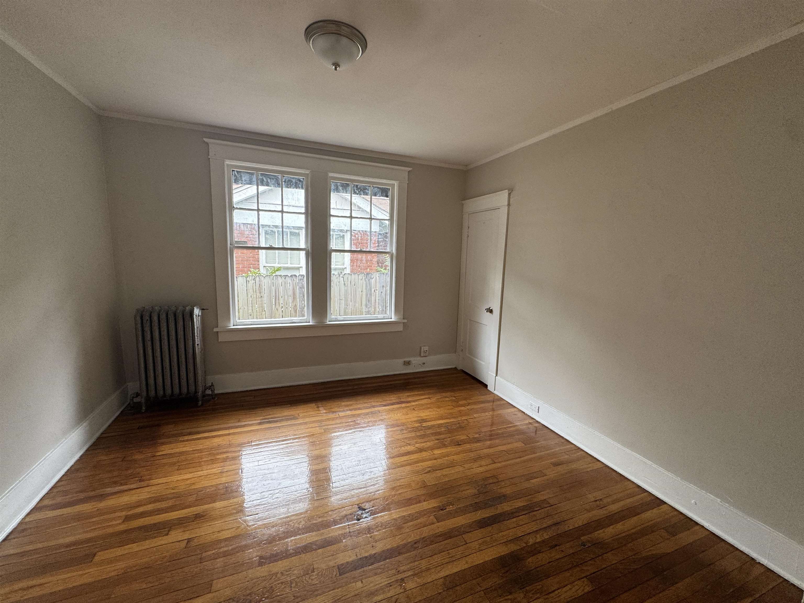 2012 Carnes Avenue Memphis, TN 38114 - Photo 8 of 28 a view of an empty room with wooden floor and a window