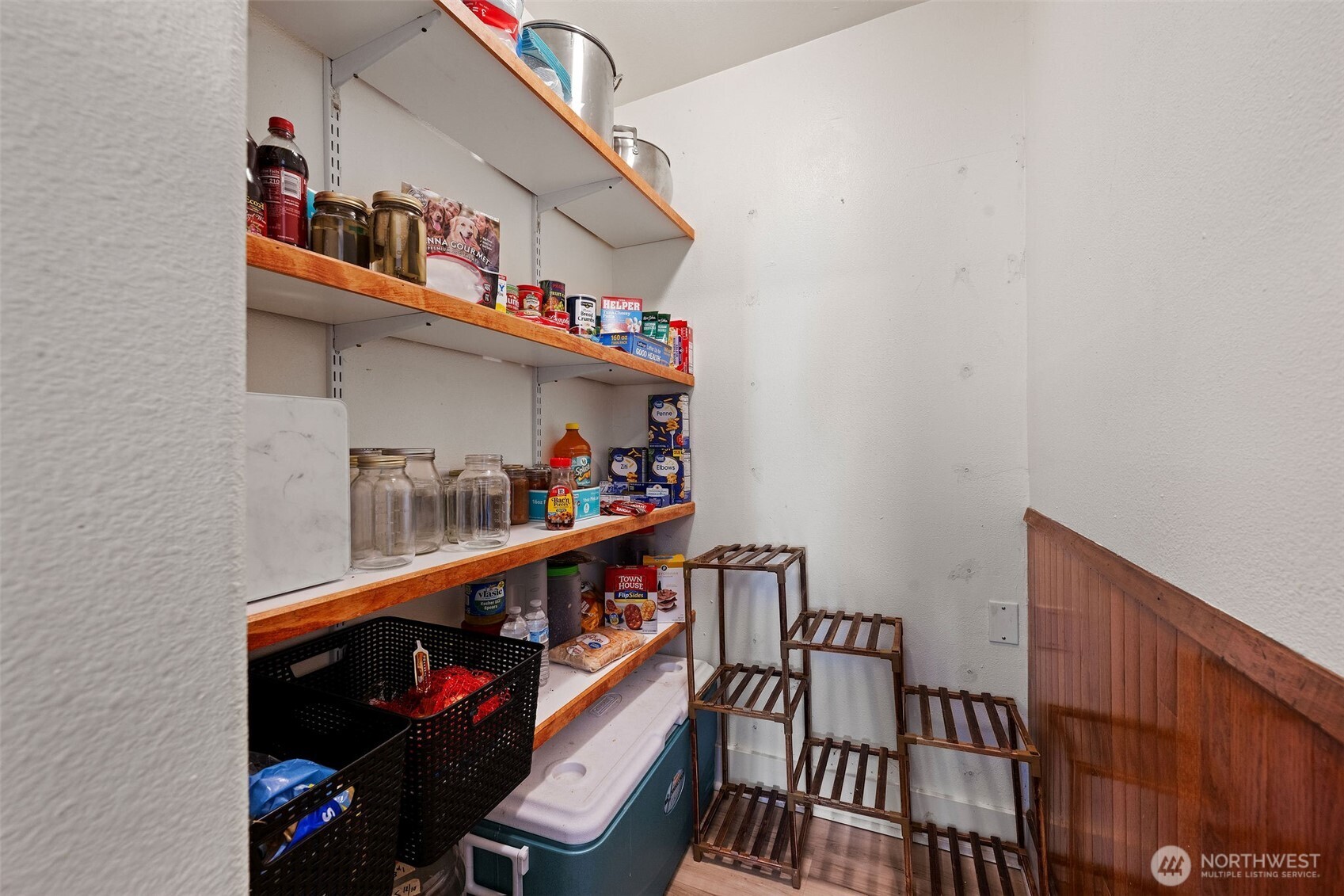 1218 Cedar Street Raymond, WA 98577 - Photo 19 of 31 a room with lots of frames on wall and a potted plant