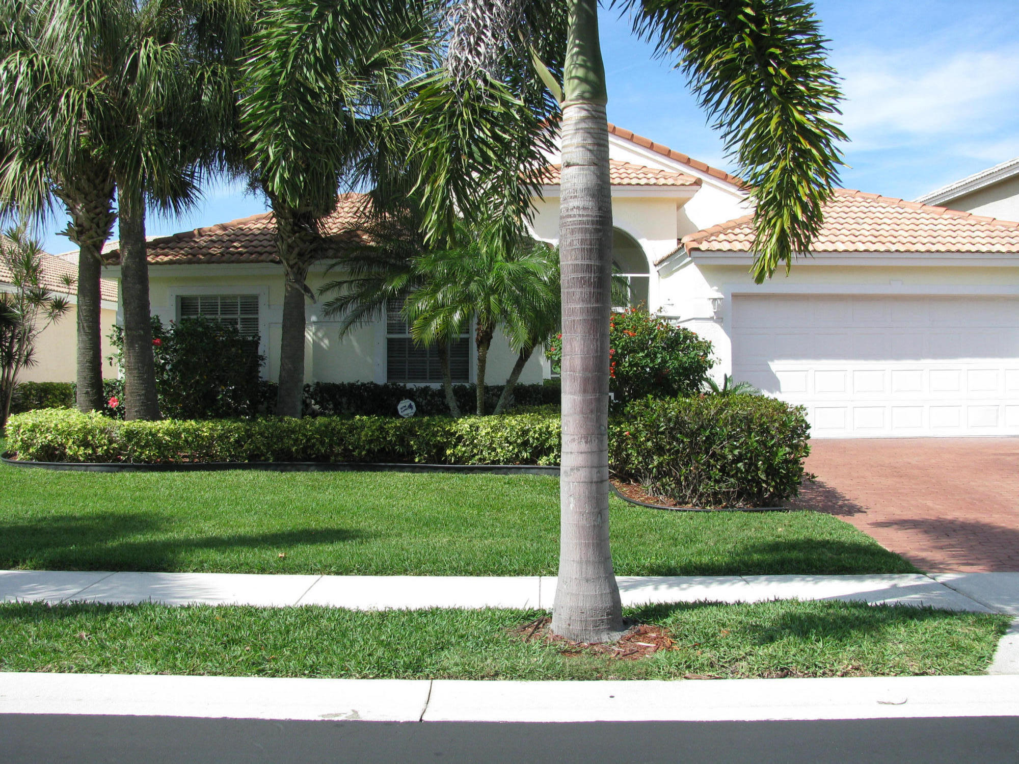 103 Waterbridge Lane Jupiter, FL 33458 - Photo 1 of 47 a view of a yard in front of a house