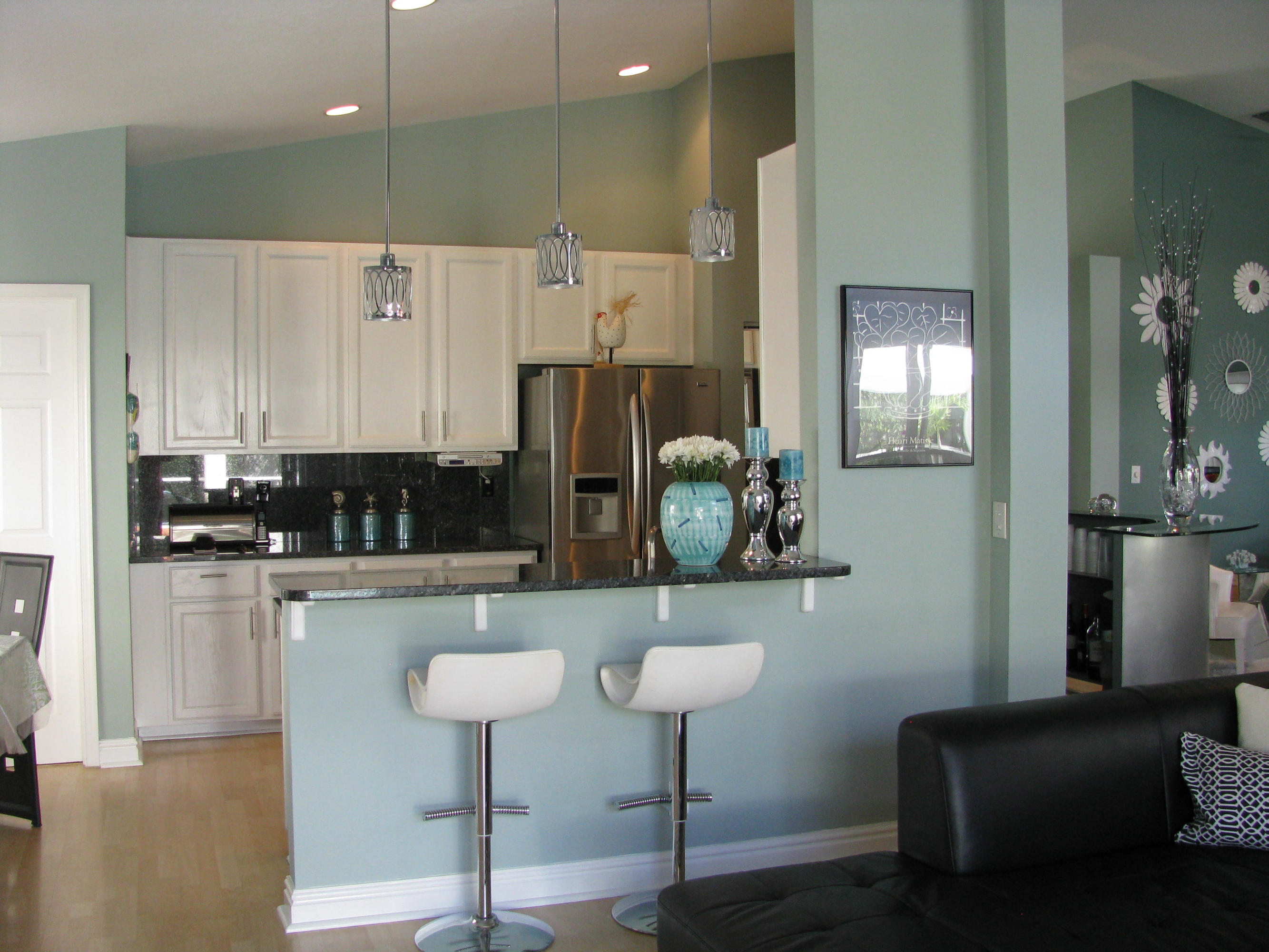 103 Waterbridge Lane Jupiter, FL 33458 - Photo 14 of 47 a kitchen with stainless steel appliances kitchen island granite countertop a refrigerator and a sink