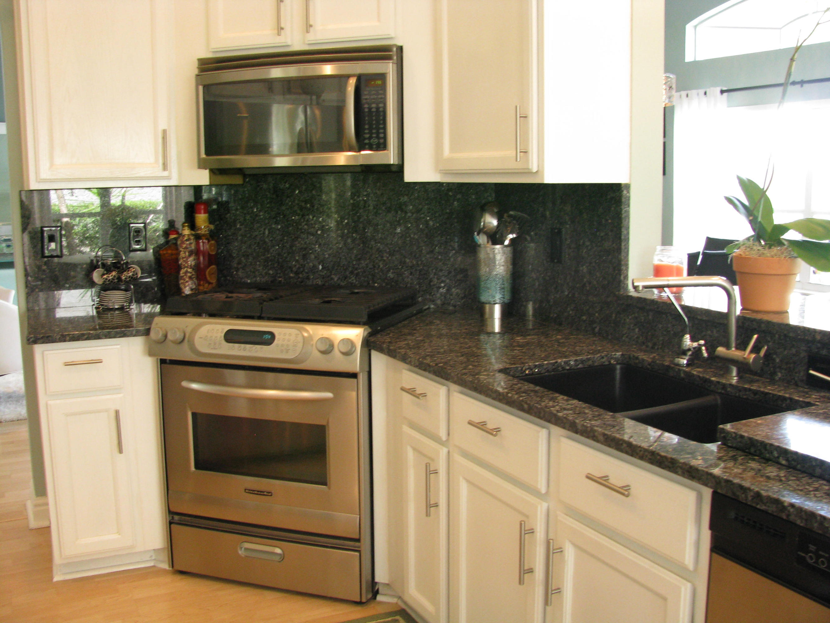 103 Waterbridge Lane Jupiter, FL 33458 - Photo 15 of 47 a kitchen with granite countertop a sink stove and cabinets