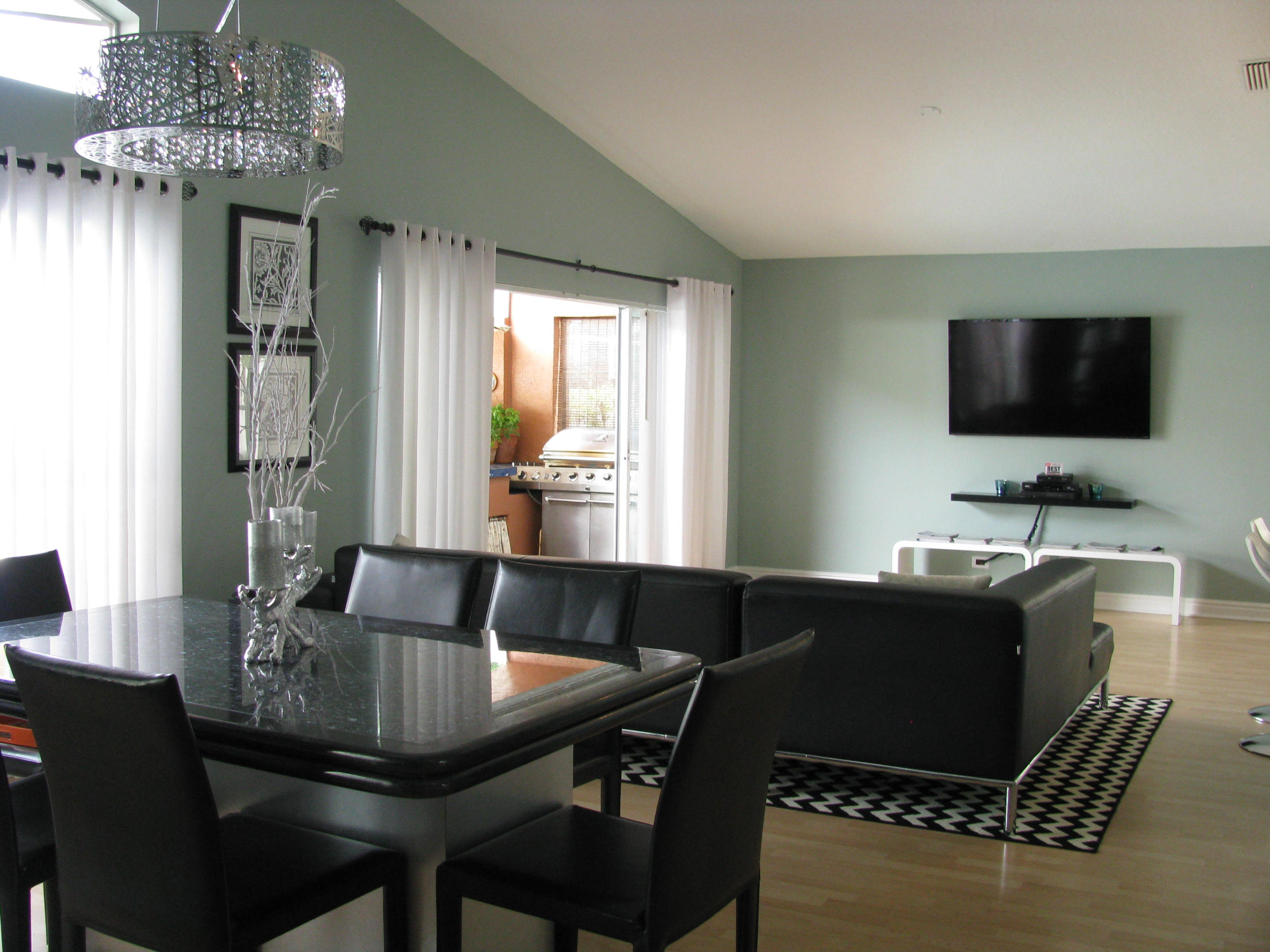 103 Waterbridge Lane Jupiter, FL 33458 - Photo 16 of 47 a living room with furniture a chandelier and a flat screen tv