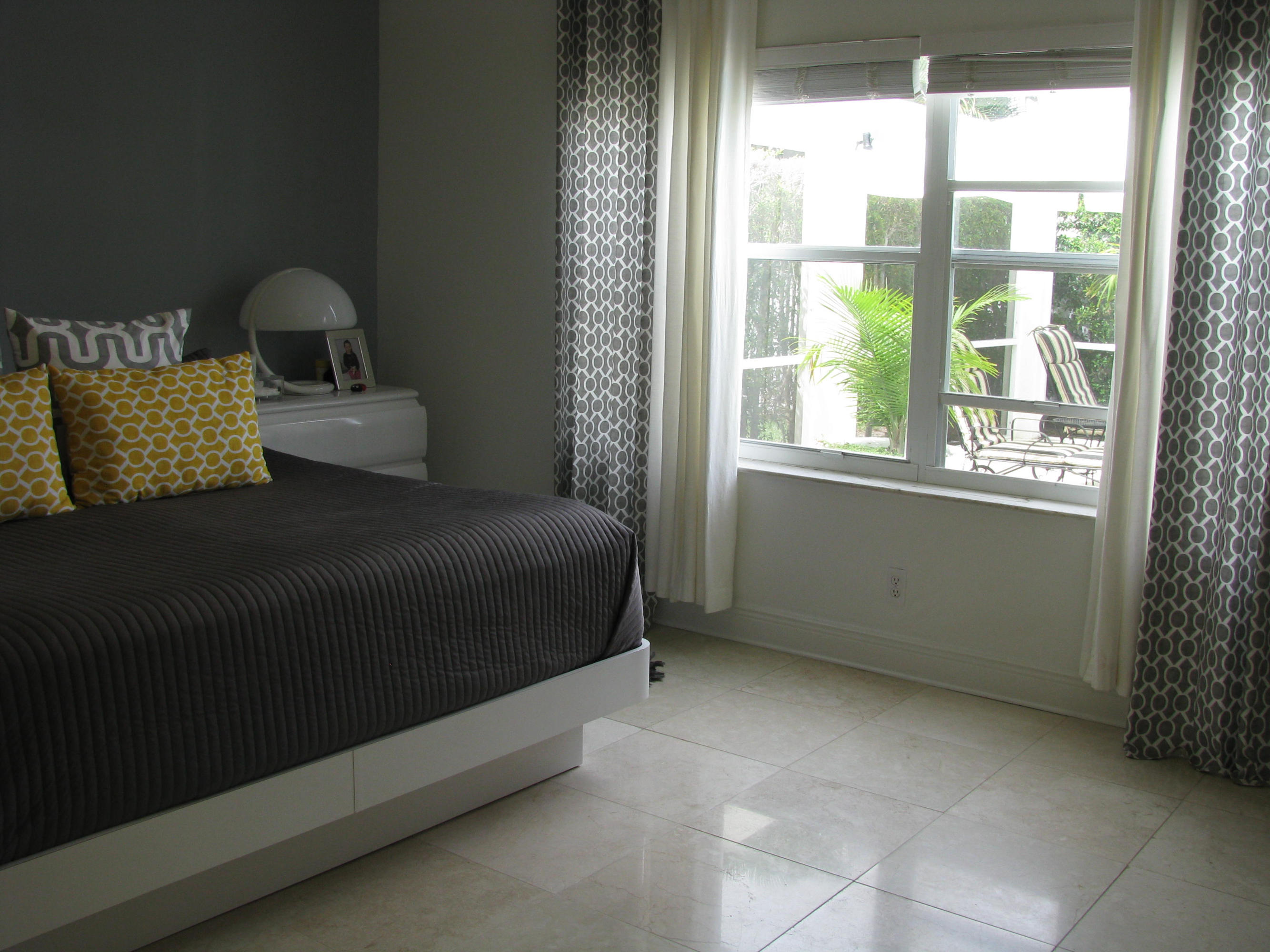 103 Waterbridge Lane Jupiter, FL 33458 - Photo 20 of 47 a bed sitting in a bedroom next to a window