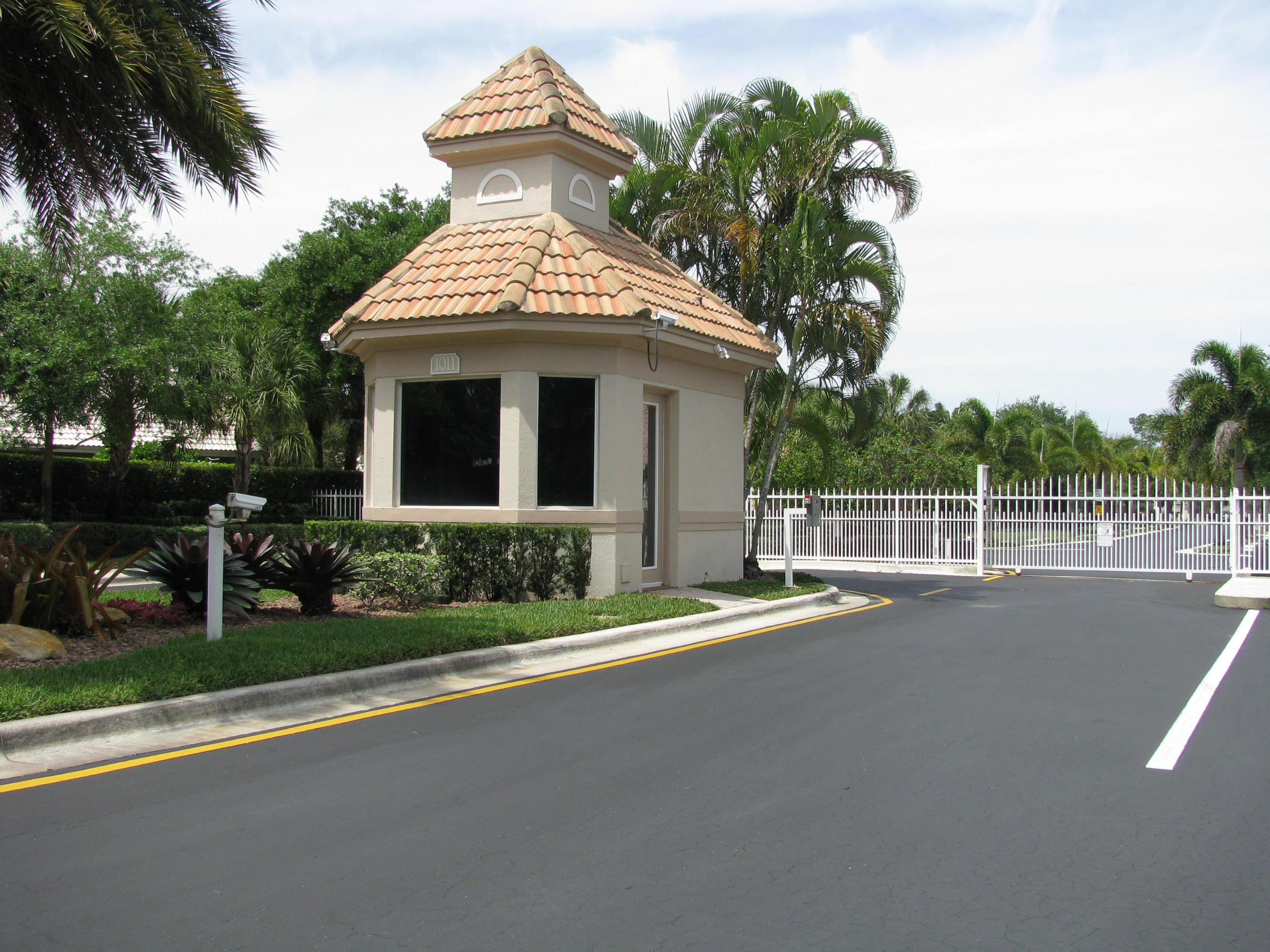 103 Waterbridge Lane Jupiter, FL 33458 - Photo 2 of 47 a view of a house with a yard and potted plants