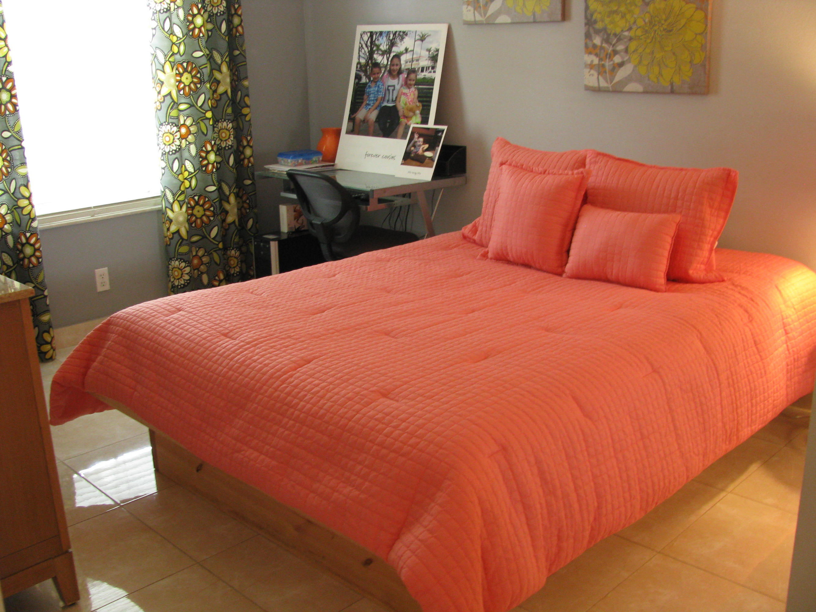 103 Waterbridge Lane Jupiter, FL 33458 - Photo 22 of 47 a bed sitting in a bedroom next to a window with wooden floor