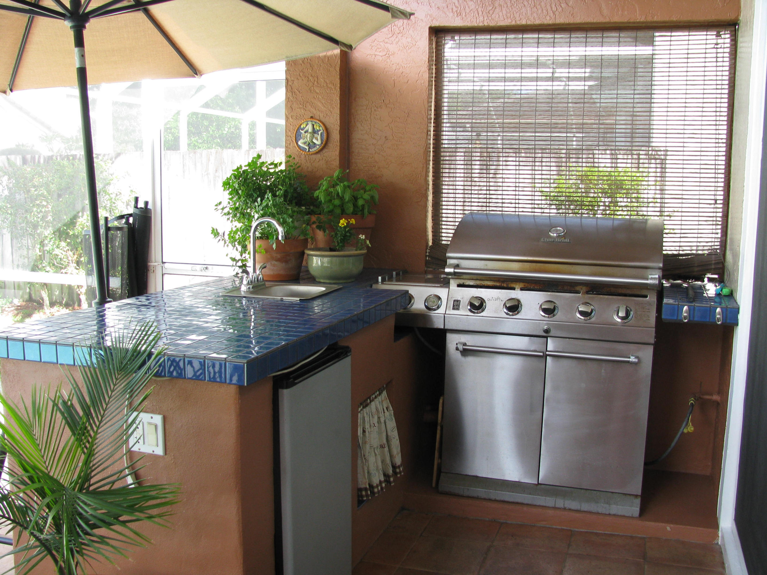 103 Waterbridge Lane Jupiter, FL 33458 - Photo 28 of 47 a kitchen with a stove and a potted plant