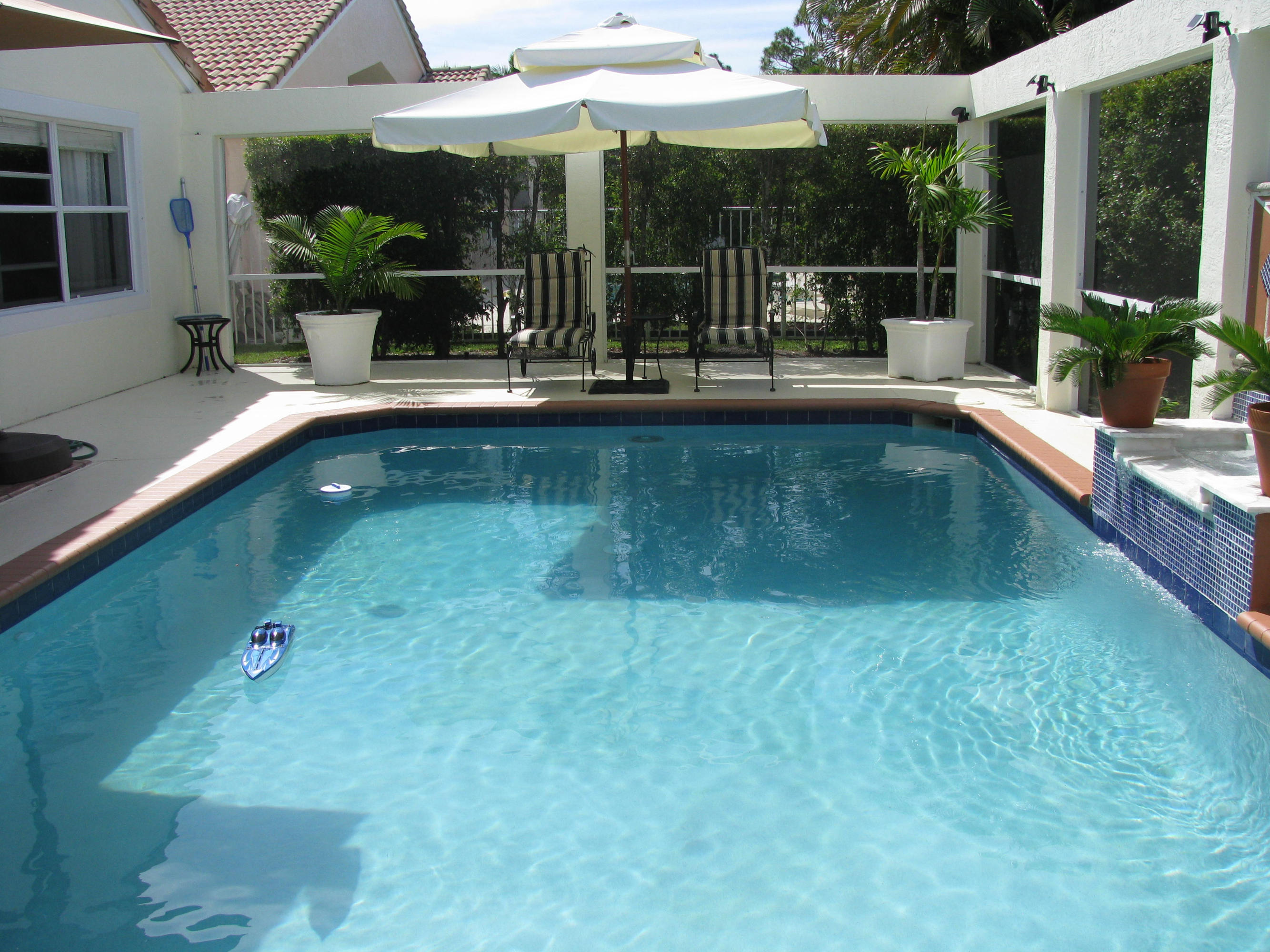 103 Waterbridge Lane Jupiter, FL 33458 - Photo 31 of 47 a view of a swimming pool with a patio