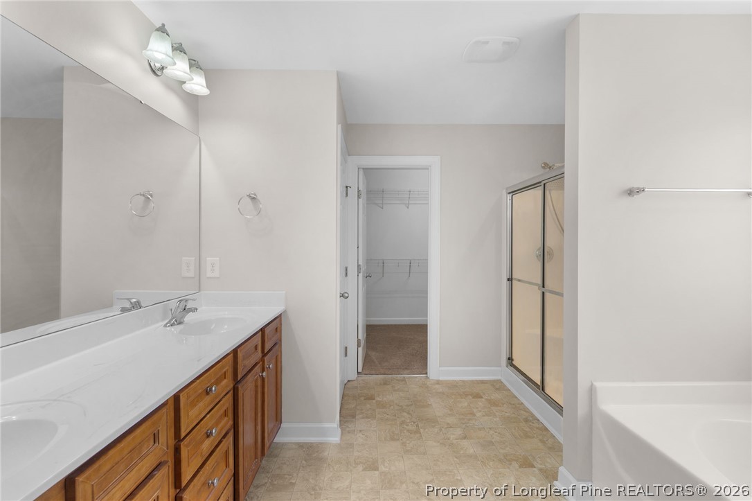 50 Huzzas Circle Cameron, NC 28326 - Photo 20 of 39 a bathroom with a double vanity sink a mirror and a shower