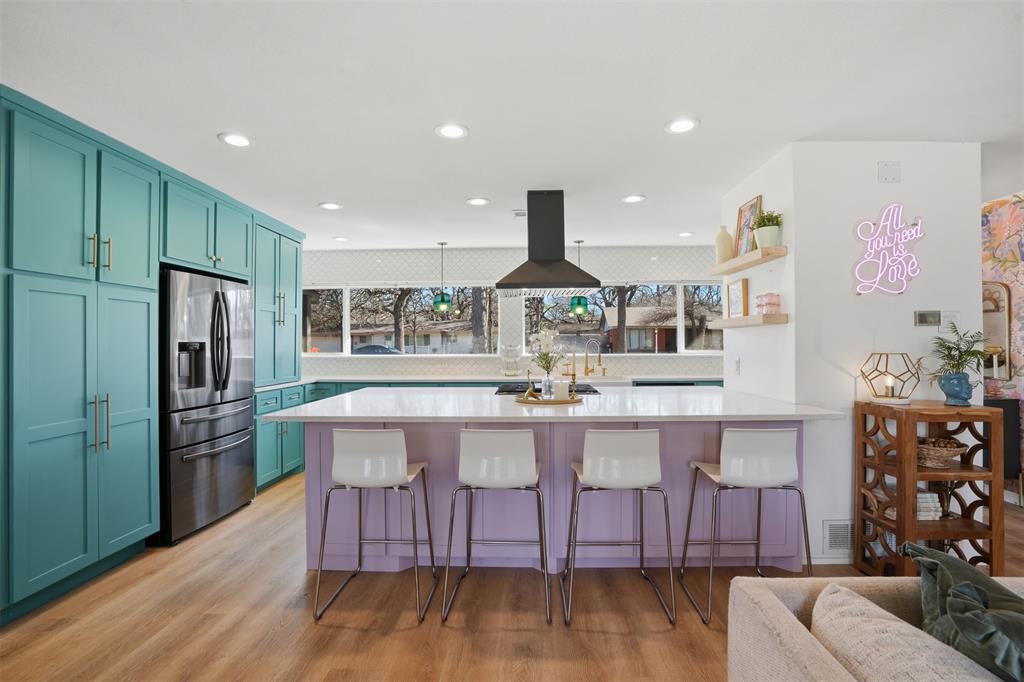 1008 Ridgewood Terrace Arlington, TX 76012 - Photo 18 of 40 a kitchen with stainless steel appliances granite countertop a kitchen island hardwood floor sink and stove