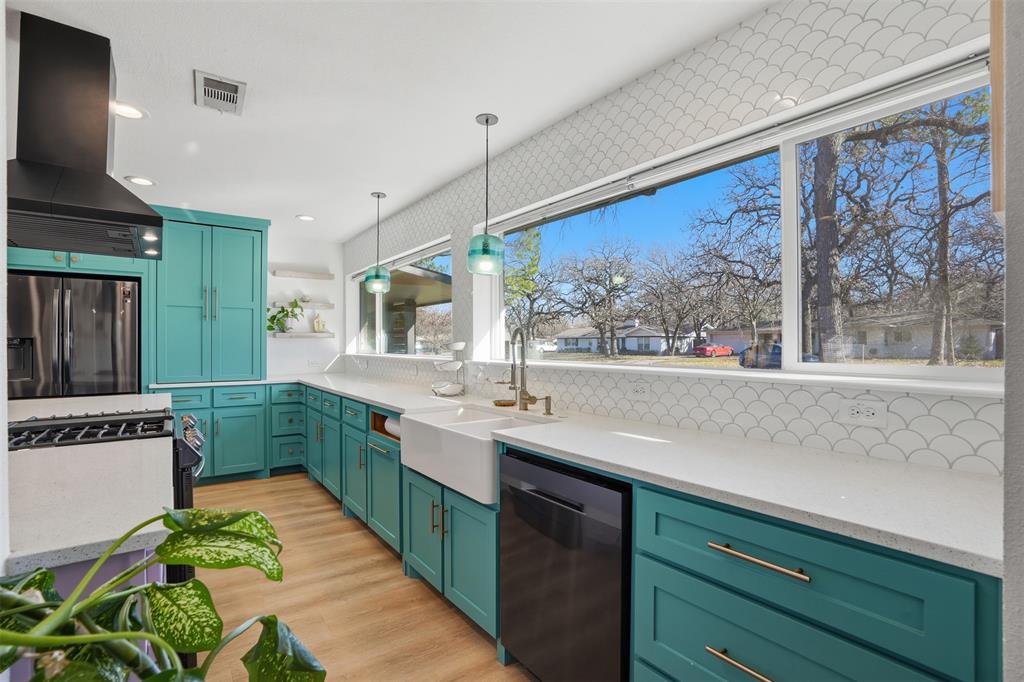 1008 Ridgewood Terrace Arlington, TX 76012 - Photo 8 of 40 a kitchen with stainless steel appliances a sink window and cabinets