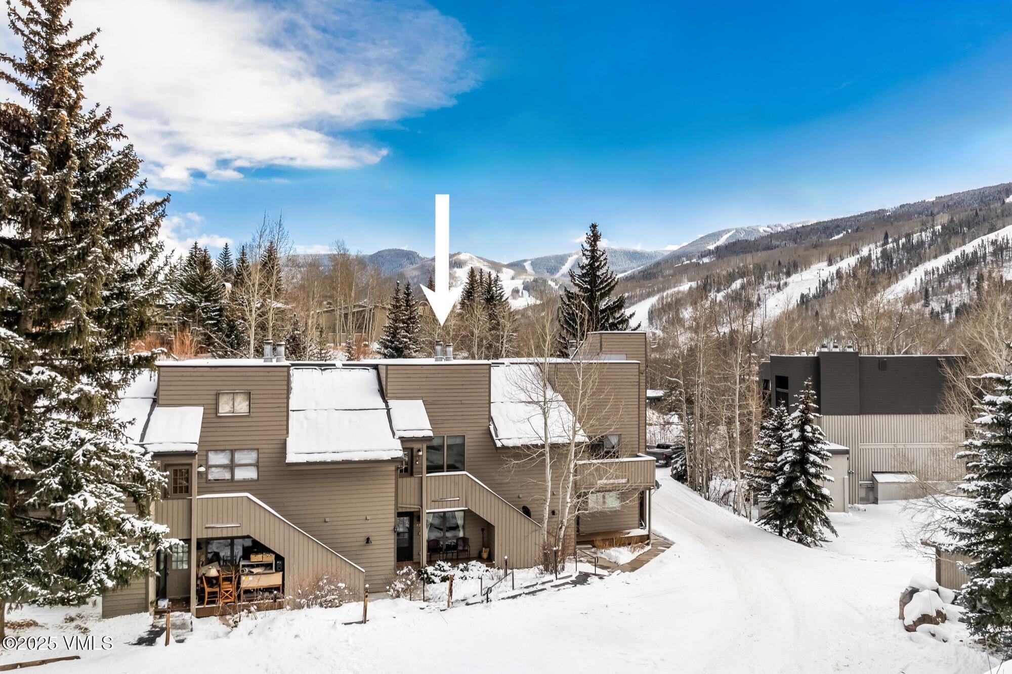 945 Red Sandstone Road, Unit A5 Vail, CO 81657 - Photo 30 of 38 a view of a terrace with a bench and trees