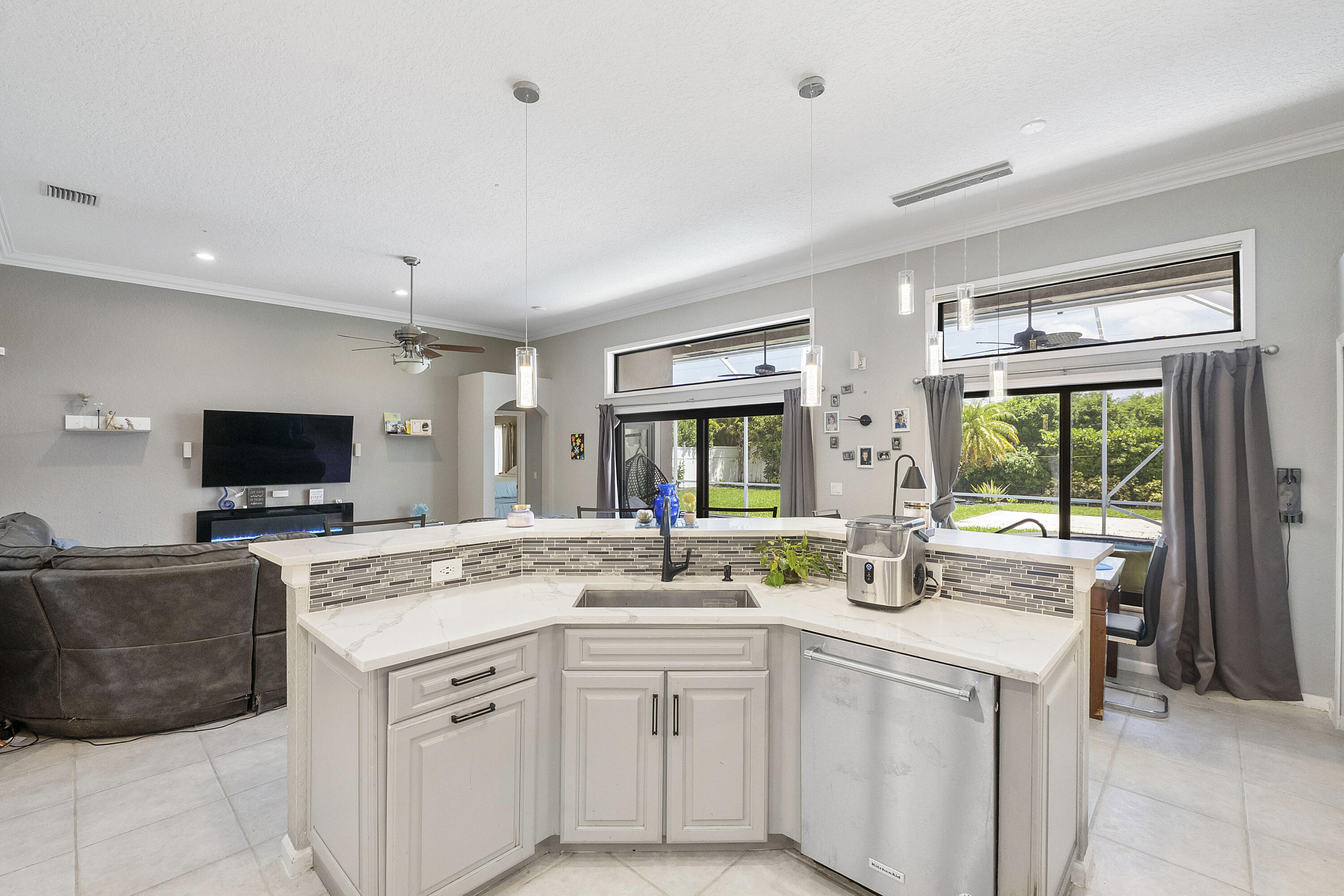 12328 St Simon Drive Boca Raton, FL 33428 - Photo 16 of 52 a living room with stainless steel appliances granite countertop a stove a sink and a refrigerator