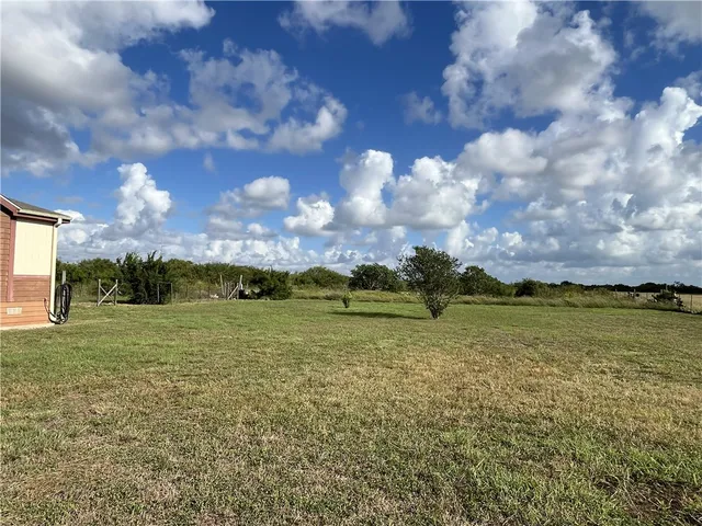 a kitchen with stainless steel appliances granite countertop a sink dishwasher a dining table and chairs with wooden floor