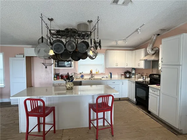 a bedroom with bed and a chandelier