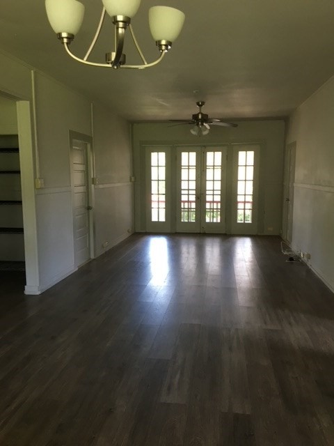 17-304 Volcano Road Kurtistown, HI 96749 - Photo 2 of 13 an empty room with wooden floor and windows