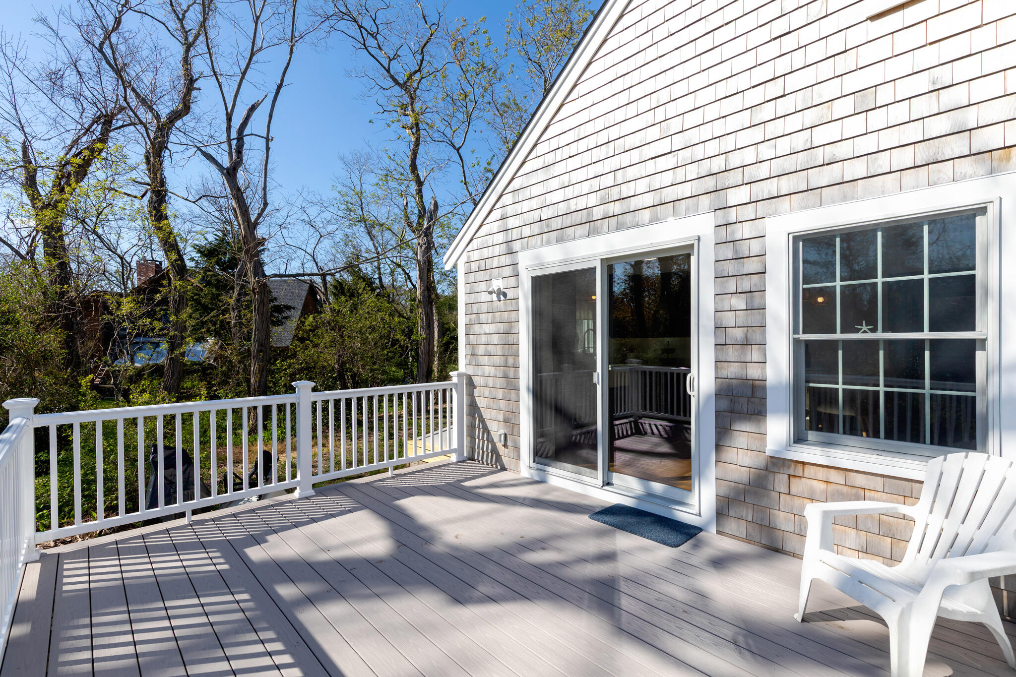 1295 Massasoit Road Eastham, MA 02642 - Photo 4 of 32 a view of a deck with a couches and floor to ceiling window