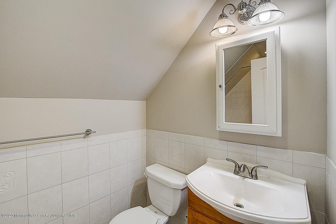 257 Lloyd Road Aberdeen, NJ 07747 - Photo 17 of 46 a bathroom with a sink mirror and toilet